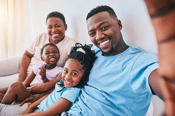 Selfie, black family and bond in a bed with smile, care and love together in their home. Portrait, memory and children with parents in bedroom hug and relax for a happy profile picture in a house.