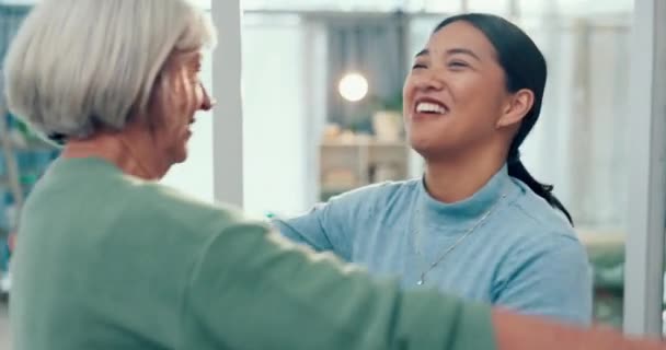 年长的女人 抱着一位老朋友 带着微笑去一家商务办公室拜访她 在理疗人员的支持和照料下 老年女性 爱心女性和快乐女性在工作场所共同生活 — 图库视频影像
