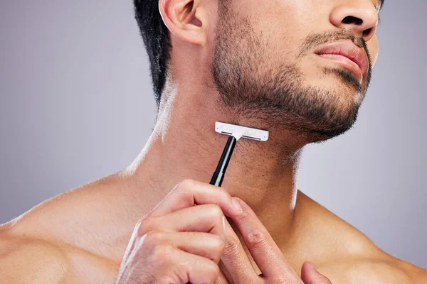 Beard hair, razor and closeup man with beauty routine, self care treatment, morning bathroom grooming and cosmetics skincare. Neck cleaning, salon wellness or studio person shaving on grey background.