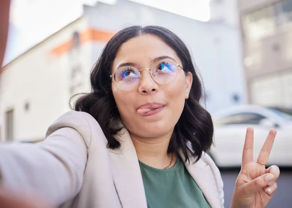 Business woman, selfie and city with peace sign, funny face or glasses for meme, finance career or street. Employee, outdoor and comic icon for memory, photography or profile picture for social media.