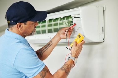 Air conditioner, meter and electrician man for ac repair, maintenance and electrical power services on fan system. Person, technician or contractor with electricity, box check and hvac engineering. clipart