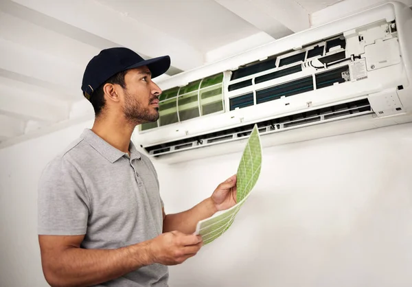 Handyman service, air conditioner technician and man, working on ventilation filter and ac repair. Contractor, maintenance or electric aircon machine expert problem solving or cleaning dust in office.