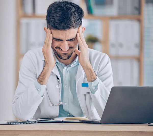 stock image Frustrated man, doctor and headache in stress, mistake or debt from burnout, pain or deadline at the hospital. Male person or medical employee in anxiety, depression or mental health at the clinic.