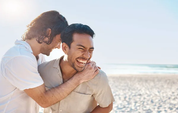 stock image Love, laugh and gay couple, men on beach with hug and smile on summer vacation together in Thailand. Sun, ocean and mockup, happy lgbt people embrace in nature for on holiday with pride, sea and fun