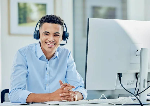 Telemarketing, portrait and man with a smile, call center and employee with headphones, tech support and customer service. Agent, consultant and person with a headset, computer and help desk for crm.