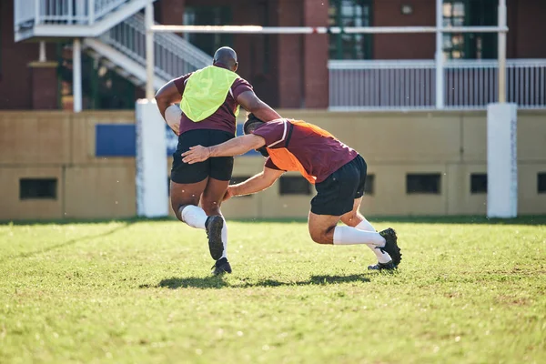 Rugby, sports and tackle with a team on a field together for a game or match in preparation of a competition. Exercise, health and teamwork with a group of men outdoor on grass for club training.