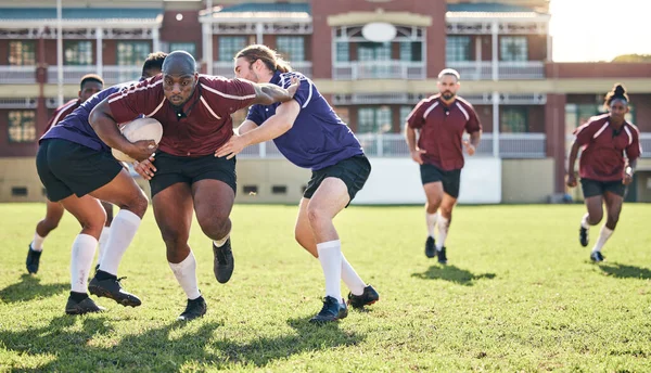 Rugby, training and tackle with a team on a field together for a game or match in preparation of a competition. Sports, fitness and running with a group of men outdoor on grass for club practice.