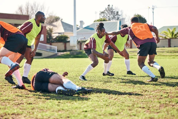 Rugby, sports and running with a team on a field together for a game or match in preparation of a competition. Fitness, training and teamwork with a group of men outdoor on grass for club practice.