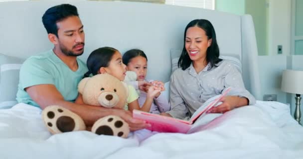 ベッド 幸せな家族 両親は子供と一緒に読書し 寝室でテディベアのおもちゃで遊んでいます サポート 朝とセキュリティのための部屋で子供たちとのケア 母親と父親の絆 — ストック動画