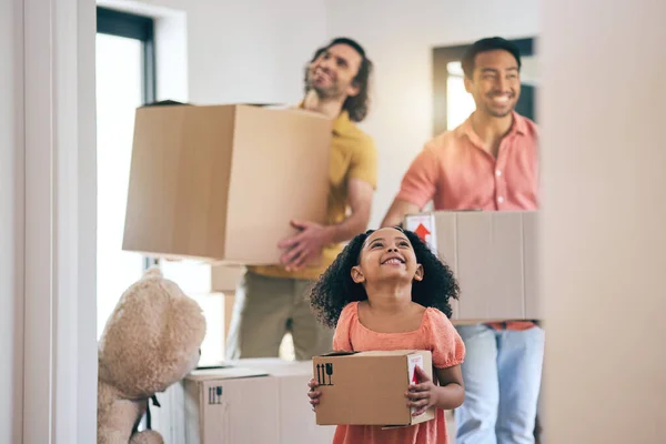 Happy, family and moving box with kid and gay parents in new home with cardboard package. Smile, child and lgbt people together with real estate and property mortgage in a house helping father.
