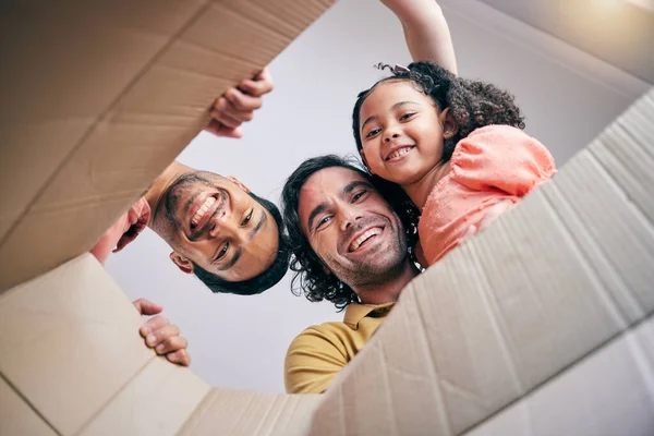 Family, open box and moving from below, portrait and smile in new house with gay father, girl kid and excited. LGBTQ men, cardboard package and happy with female child for start, life and property.