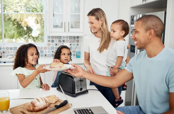 Mom, dad and kids with toast, breakfast and happy in kitchen with interracial love, bonding and care. Parents, young children and together with bread for family, father or work from home in morning.