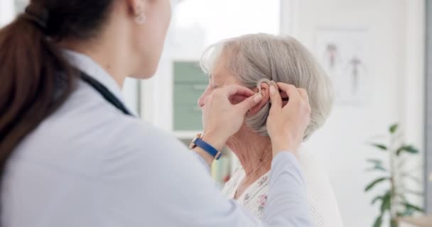 Kadın Doktor Danışmanlık Klinikteki Yaşlılara Yardım Için Işitme Cihazı Şitme — Stok video