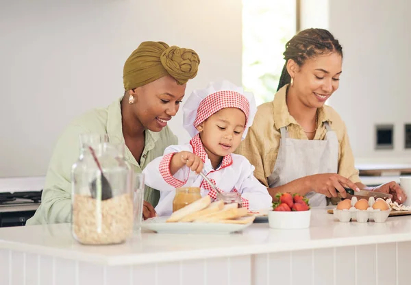 Gay family, child and cooking in home kitchen for learning, development and love. Adoption, lesbian or lgbtq women or parents and a happy young kid together to cook breakfast food with care and help.