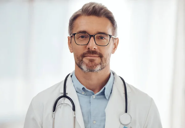 Doctor, senior man and portrait with health and physician at hospital, stethoscope and cardiology surgeon. Professional headshot of male person, expert in medical and cardiovascular healthcare.