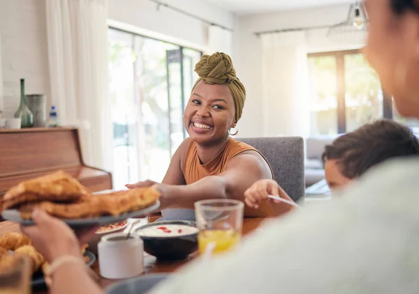 Food plate, breakfast and happy family eating, giving meal or enjoy morning time together, lunch or brunch at home. Happiness, hungry people or relax black woman, mother and parent pass snack product.