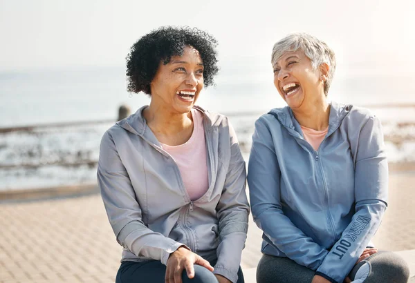老年妇女 与朋友一起嬉笑和海滩 训练和坐在室外的夏天 早上锻炼 休息和成熟的女性 加上滑稽的笑话和海上健康锻炼 — 图库照片
