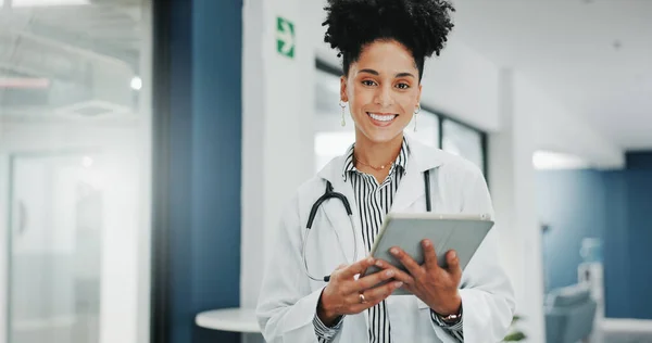 Face of happy woman doctor on tablet for medical research, hospital management and telehealth service. Portrait of young black person in professional healthcare career, job or clinic on digital tech.