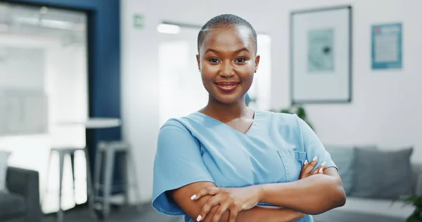 Nurse, face or arms crossed in busy hospital for about us, medical life insurance or wellness support. Smile, happy or healthcare black woman in portrait, confidence trust or help medicine internship.