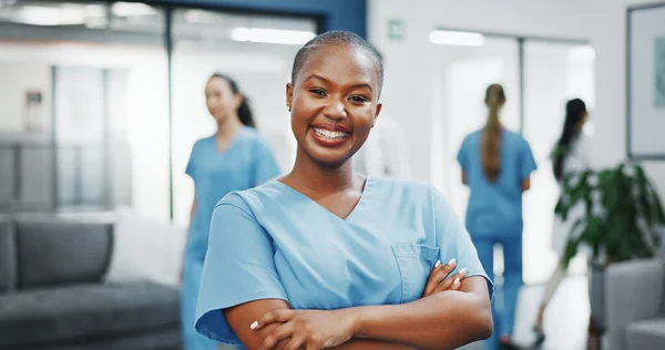 Nurse, face or arms crossed in busy hospital for about us, medical life insurance or wellness support. Smile, happy or healthcare black woman in portrait, confidence trust or help medicine internship.