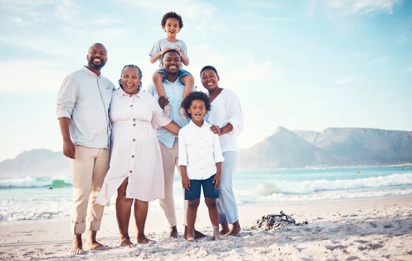 Happy, travel and portrait of black family at beach for smile, summer break and bonding on vacation. Relax, holiday trip and generations with parents and children for quality time, sunshine and fun.