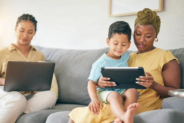 stock image Relax, tablet and family kid, mom or bisexual people reading online web story, e learning article and distance education. LGBTQ, lesbian mothers or relax gay woman teaching child on home lounge sofa.