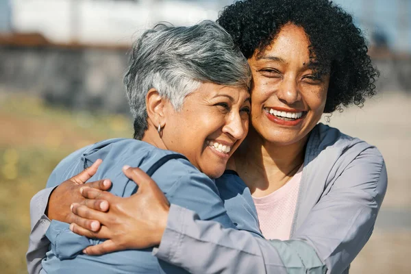 Senior women, workout hug and smile closeup with fitness and exercise outdoor for health. Elderly people, sport training and happy friends with bonding and embrace after running of a mature athlete.