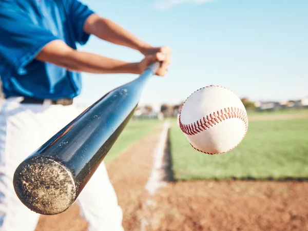 Baseball, hit and person on field for in closeup training, sports and fitness in outdoor competition. Hands, ball and bat softball player with power strike at stadium for action, speed or performance.
