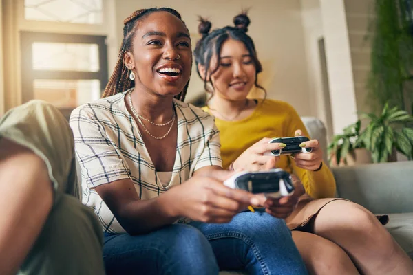 Friends, women and gaming on tv in home living room on sofa, smile and having fun online. Television, girls and play video game on couch, esports competition and bonding to relax in house together.