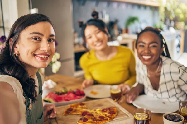 Friends, selfie and pizza with women in kitchen for happy, social media and fast food. Smile, profile picture and post with portrait of people at home for party, celebration and photography together.