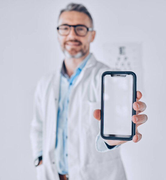 Phone, screen and optometrist in eye exam, test or booking an assessment for vision with mobile app, internet or website. Cellphone, mockup and doctor testing eyesight in office with technology.