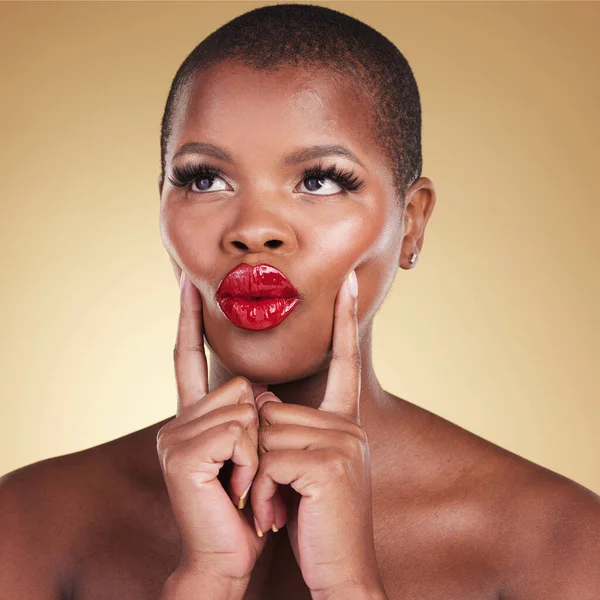 Beauty, makeup and a black woman with red lipstick in studio for skin care, glow and cosmetics. Headshot of african person or model with facial shine, dermatology and pouting lips on beige background.