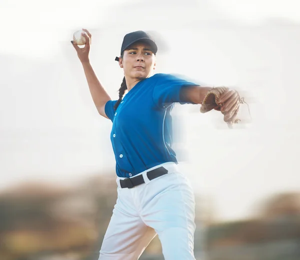 Baseball, ball and a woman pitching outdoor on a sports pitch for performance and competition. Professional athlete or softball pitcher with fitness for game, training or exercise on field or stadium.