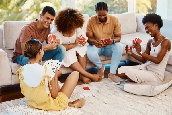 Game, happy or friends playing cards, poker or black jack at home for gambling together in a holiday party. Smile, men or group of women laughing to relax in living room in a fun match competition.