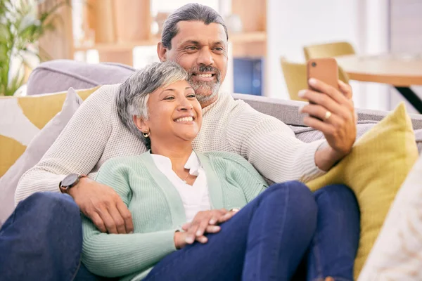 Selfie, happy and mature couple on couch with smile for social media post, profile picture and memories. Marriage, love and man and woman take photo in living room for bonding, relationship and relax.