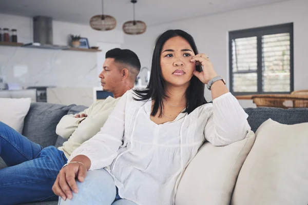 Frustrated couple, fight and conflict in divorce, argument or disagreement on living room sofa at home. Unhappy man and woman in breakup, cheating affair or dispute from toxic relationship in house.