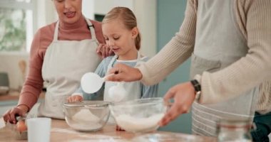 Anne, baba ya da kız mutfakta kurabiye pişirmeyi öğreniyor ya da aile evinde yemek tarifi hazırlıyor. Öğretmenlik, ebeveynlik ya da çocuğun çocuk gelişimi için kek pişirmesi ya da anne ve babayla bağ kurması..