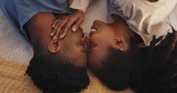在非洲 在床上 亲吻和爱情中的黑人夫妇在亲密的支持 结合和婚姻中共同生活 男人和女人在卧室里从上到下抱着善意 信任和早起的关怀 放松了下来 — 图库视频影像