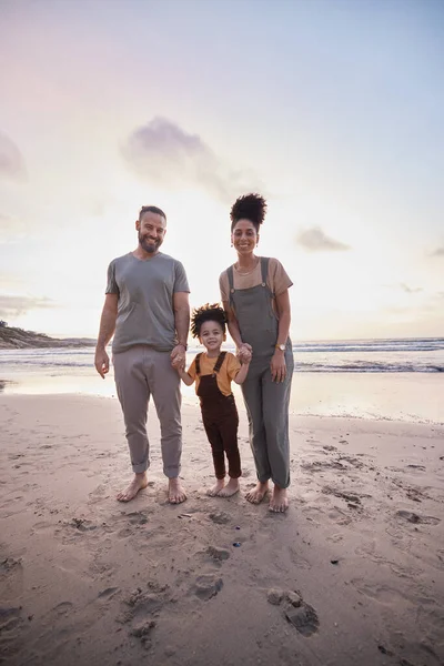 Portrait, sunset and family holding hands, beach and bonding with vacation, travel and ocean getaway. Happy parents, mother or father with girl, child or sand with seaside holiday, adventure and love.