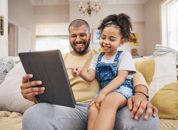 Happy, pointing and a child with a father and tablet for a cartoon, movie and streaming games. Smile, family and a dad with a girl kid and gesture to technology for a show or social media in a house.