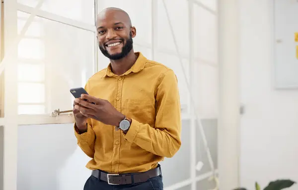 stock image Happy black man, portrait and typing on smartphone in office for social media, networking and mobile contact. Business employee with phone, reading tech notification and information with digital chat.