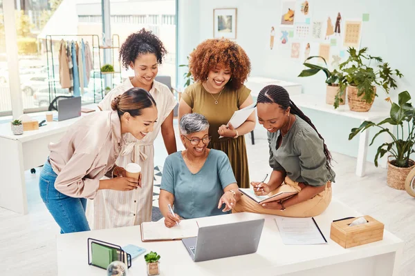 Happy, teamwork or women with laptop for fashion design, planning or draft online for clothing line. Smile, mentor or mature designer speaking, training or talking to people for advice in internship.