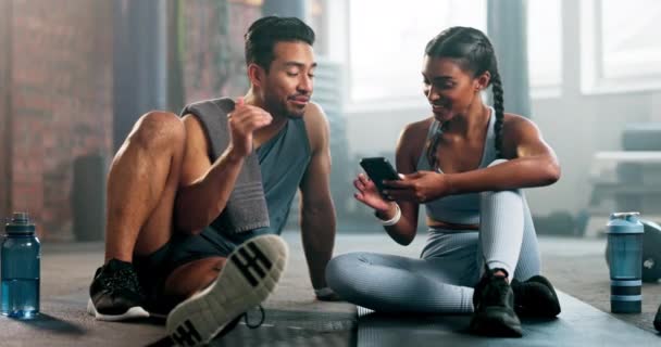 电话和谈话健身在健身房训练或锻炼应用在互联网上 亚洲男人和印度女人或健身朋友与智能手机好的评论或同意签署私人教练 — 图库视频影像