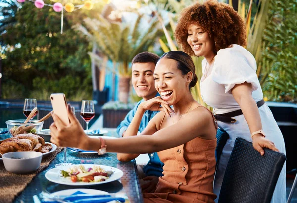 Friends, food and selfie at outdoor table for holiday, Christmas or thanksgiving on social media. Young women, man or group with photography or influencer profile picture for happy brunch celebration.