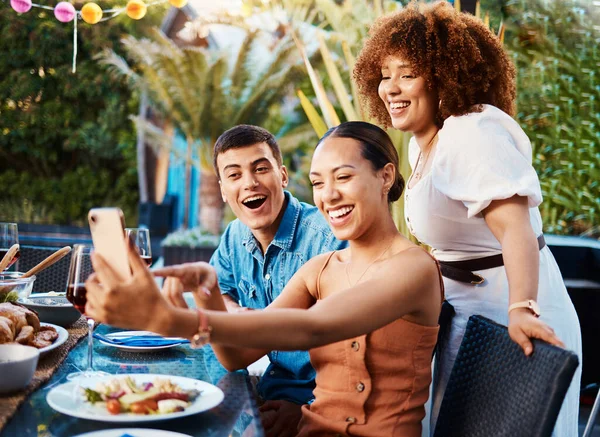 Friends, food and selfie at brunch table for holiday, Christmas or thanksgiving on social media and wow or excited. Young women, man and group photography with influencer profile picture outdoor.