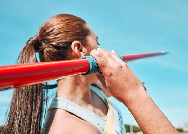 Woman, javelin and olympic athlete in sports competition, practice or training in fitness on stadium field. Active female person or athletic competitor throwing spear, poll or stick in distance.