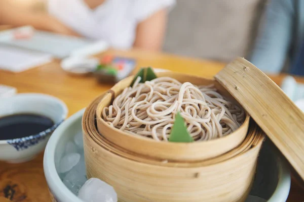 Restaurant, bamboo and closeup of a bowl of noodles for authentic Asian cuisine for diet. Food, steamer pot and zoom of Japanese ramen for a nutrition meal for dinner, lunch or supper at a diner