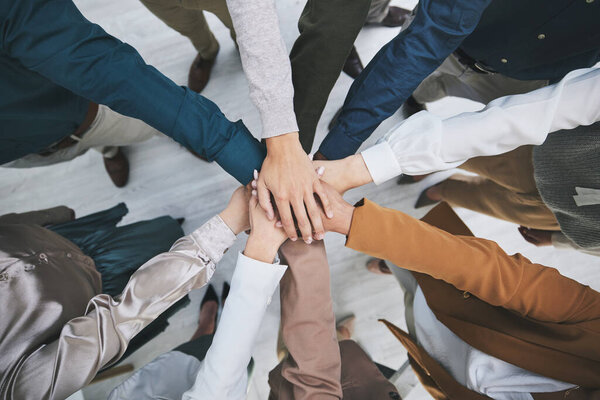 Hands together, team and support, solidarity and business people with top view, stack and community. Synergy, cooperation and huddle, collaboration and corporate group with trust, meeting and mission.