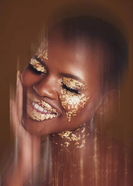 Gold beauty, spa mask and woman with blur in studio with glitter cosmetics and sparkle art. Brown background, African female model and shine from paint and skin glow with golden luxury treatment.