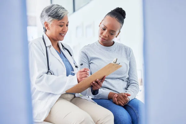 Doctor, women and checklist in healthcare support, hospital services and patient history, charts or results. Senior nurse writing on clipboard for registration, clinic sign up or medical consultation.